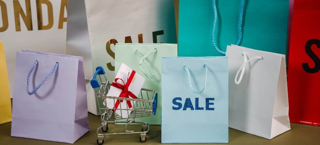 A bunch of gift bags with some of them having a “sale” sign on them.